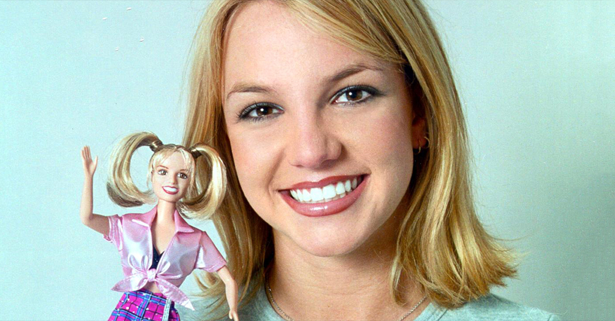 Young Britney Spears holding a Britney Spears doll.
