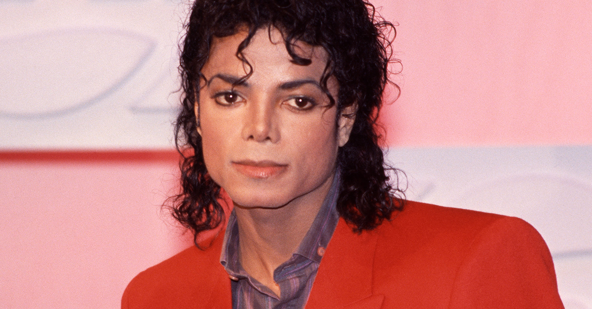 Portrait of Michael Jackson, wearing a red blazer.