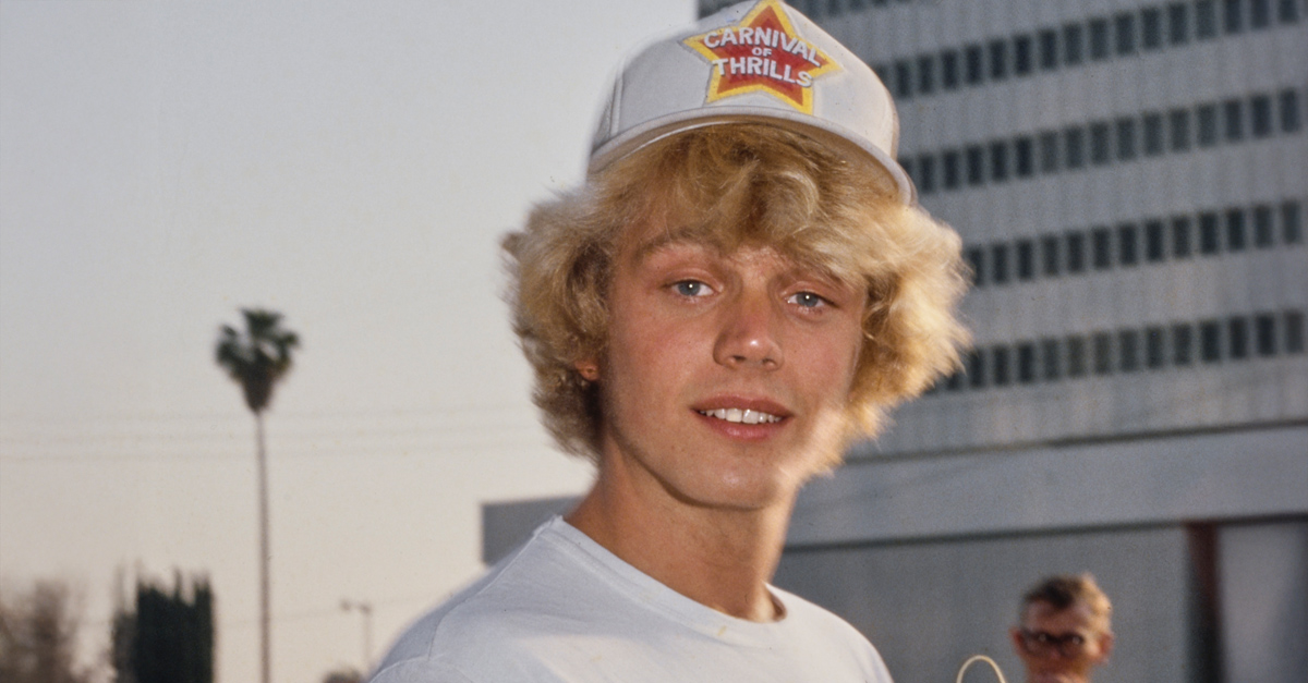 American actor and singer John Schneider, wearing a white t-shirt and a 'Carnival of Thrills' baseball cap, United States, circa 1980. 'Carnival of Thrills' is the title of an episode in the CBS action-adventure drama 'The Dukes of Hazzard'.