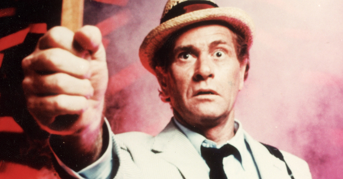 American actor Darren McGavin holds up a crucifix in a still from the television series, 'Kolchak: The Night Stalker,' c. 1974.