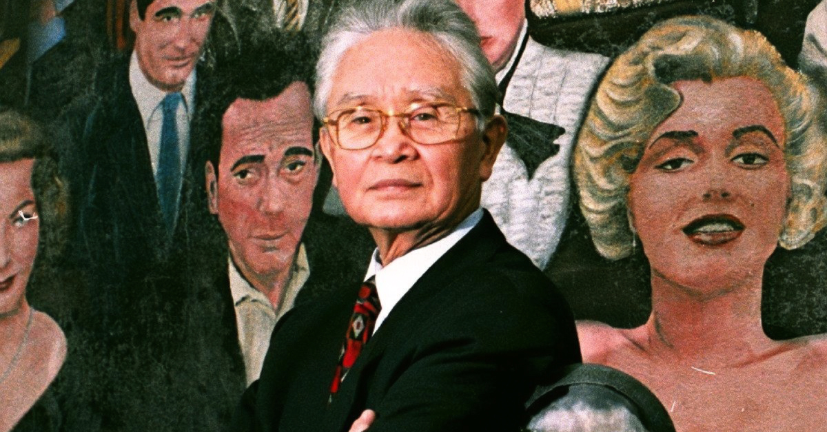 Dr. Thomas Noguchi photographed besides a mural of Hollywood stars who are dead, off Hollywood Boulevard