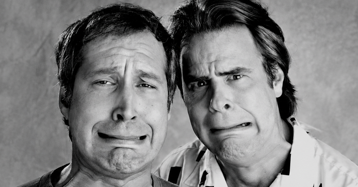 Chevy Chase and Dan Aykroyd comically grimace at the camera in Los Angeles in February of 1986