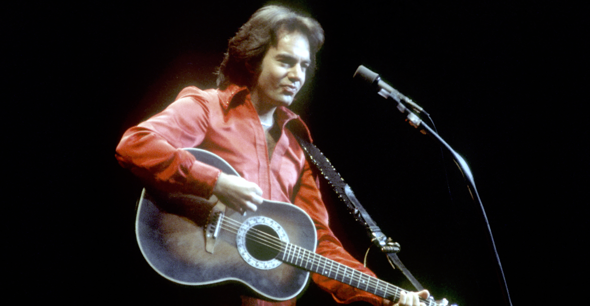 LOS ANGELES - CIRCA 1980: Singer Neil Diamond performs onstage wearing a red jumpsuit
